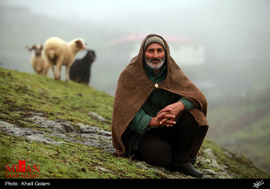 چوپانی در زیر باران پاییزی با لباس دست دوز پوست گوسفند